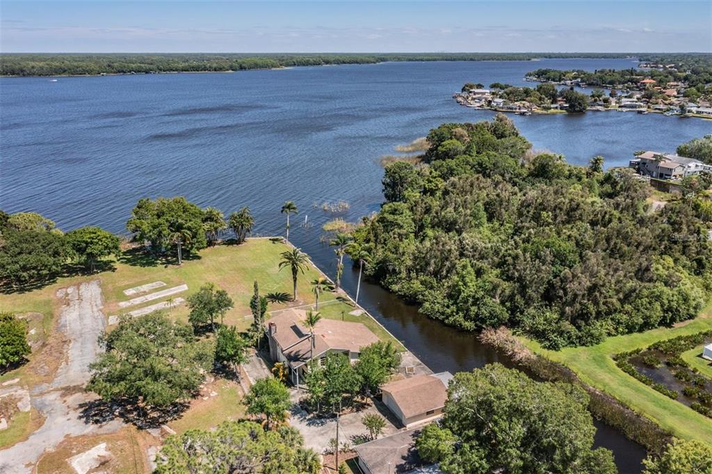 an aerial view of a house with a lake view