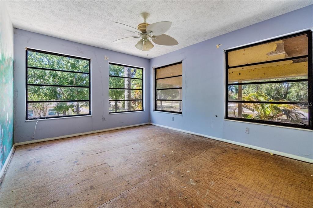 2620 Trent Road Palm Harbor, FL 34684 - Photo 12 of 21 an empty room with windows and ceiling fan