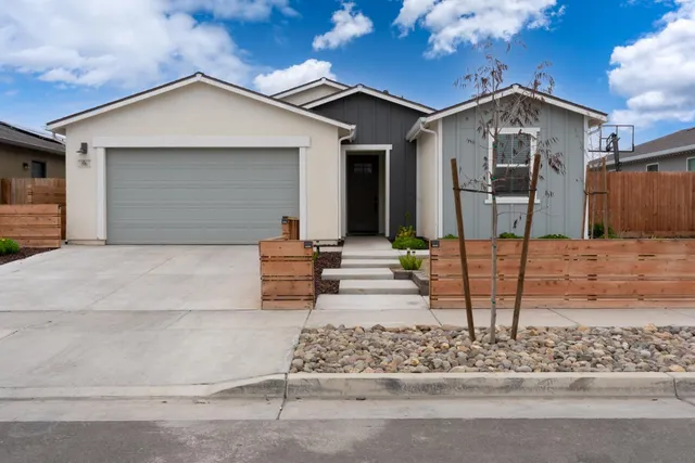 a front view of a house with garden