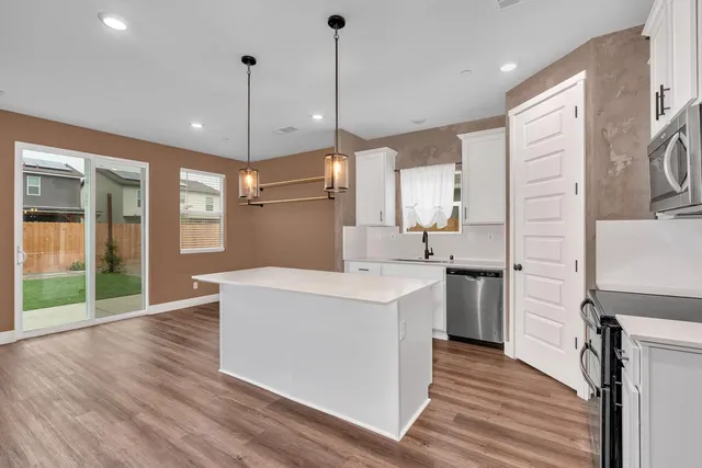 a view of a room with window wooden floor and front door