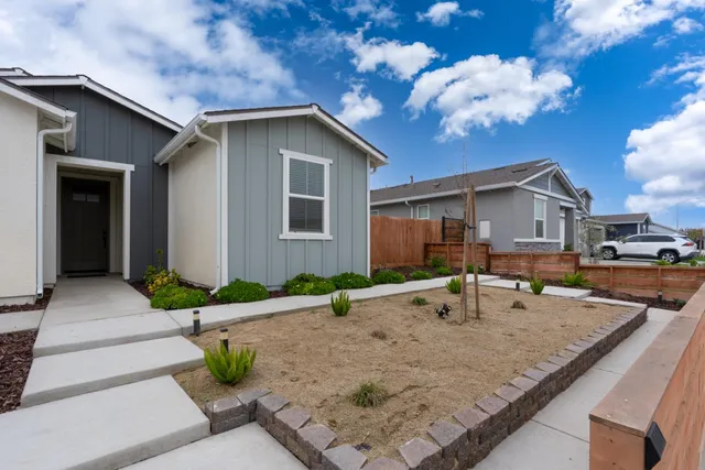 a front view of a house with garden