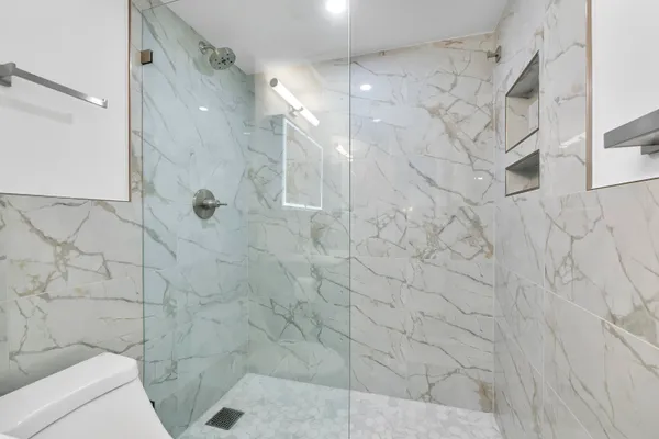 a bathroom with a sink toilet and shower