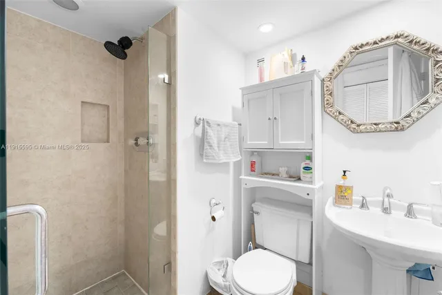 a bathroom with a sink a toilet and a mirror