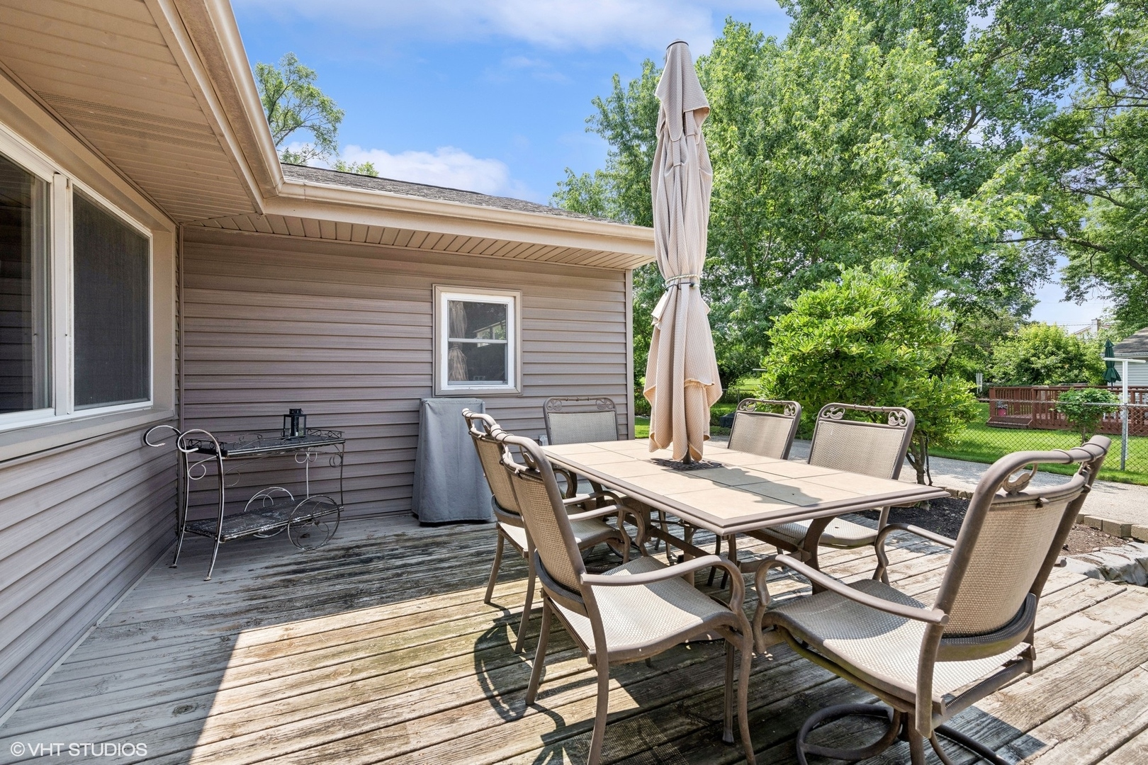 73 Golfview Road Lake Zurich, IL 60047 - Photo 22 of 34 a view of a patio with table and chairs with wooden floor and fence