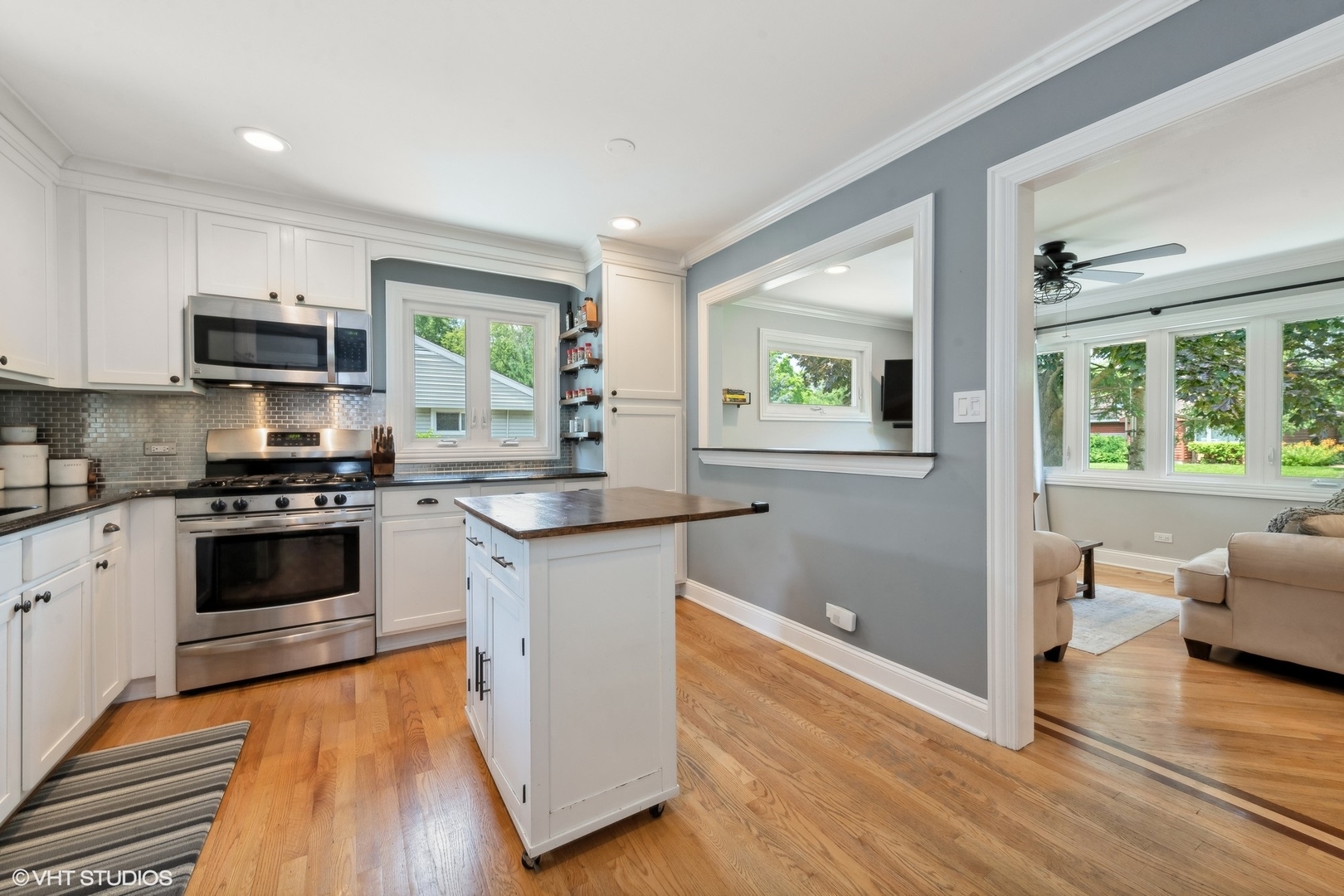 73 Golfview Road Lake Zurich, IL 60047 - Photo 8 of 34 a kitchen with granite countertop a stove a sink and a microwave