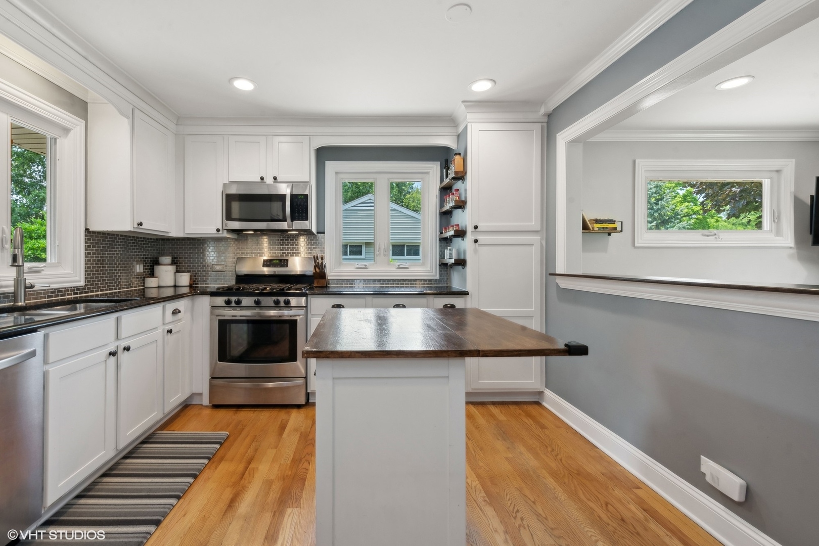 73 Golfview Road Lake Zurich, IL 60047 - Photo 10 of 34 a kitchen with stainless steel appliances granite countertop a sink a stove top oven a counter space and cabinets