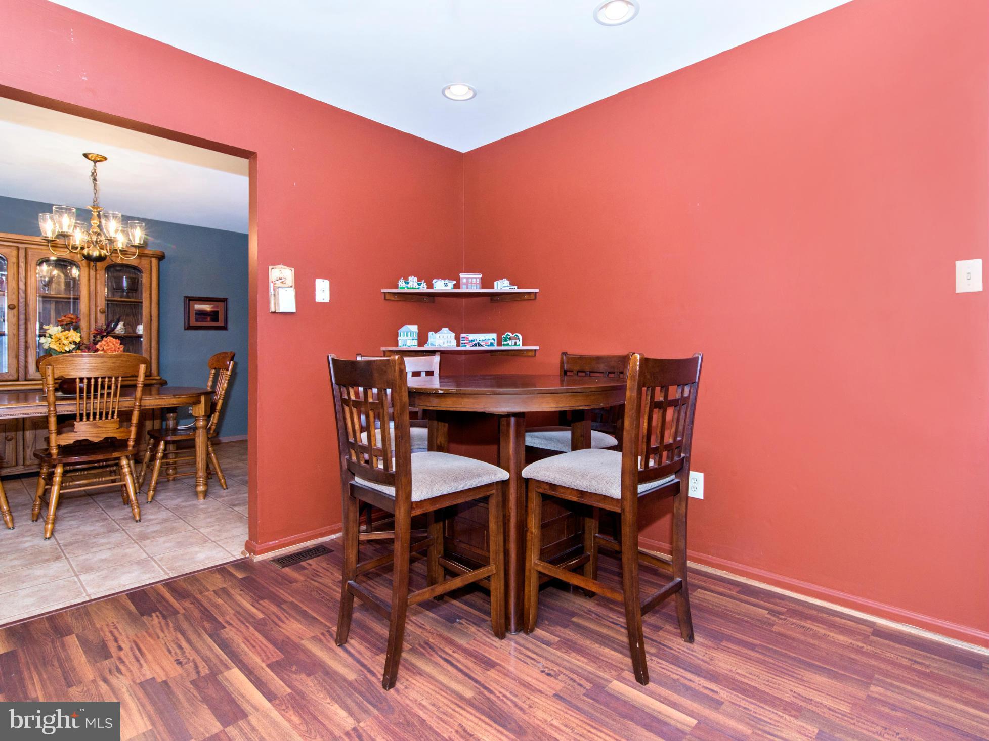 127 Summit Hall Road Gaithersburg, MD 20877 - Photo 11 of 30 a dining room with furniture and wooden floor