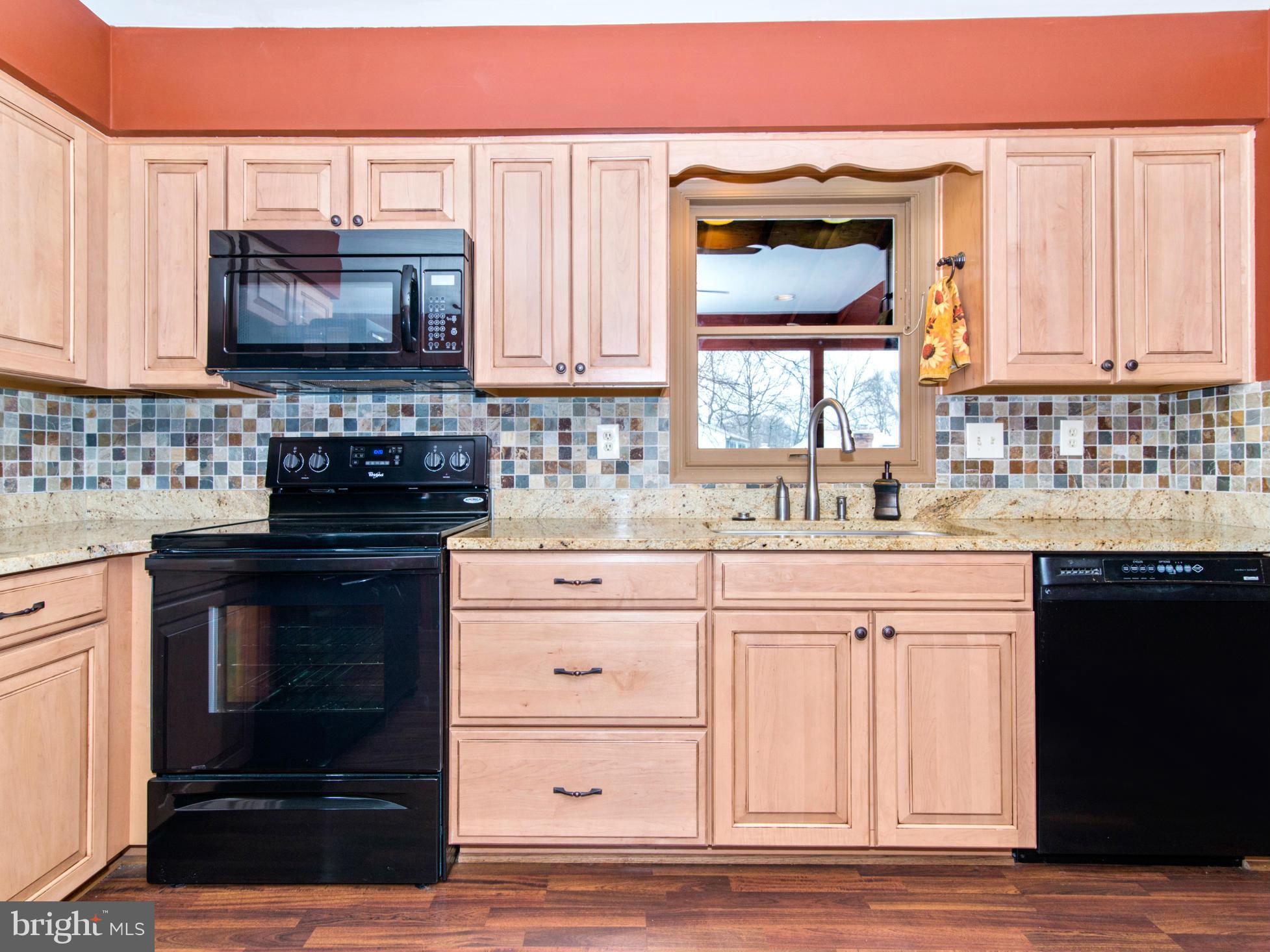 127 Summit Hall Road Gaithersburg, MD 20877 - Photo 12 of 30 a kitchen with granite countertop a stove a sink and a microwave