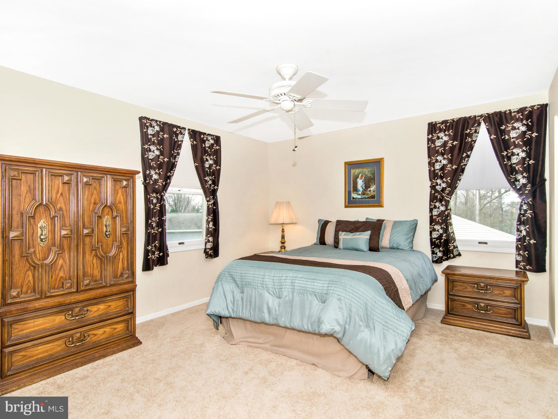 127 Summit Hall Road Gaithersburg, MD 20877 - Photo 18 of 30 a spacious bedroom with a bed and cabinet
