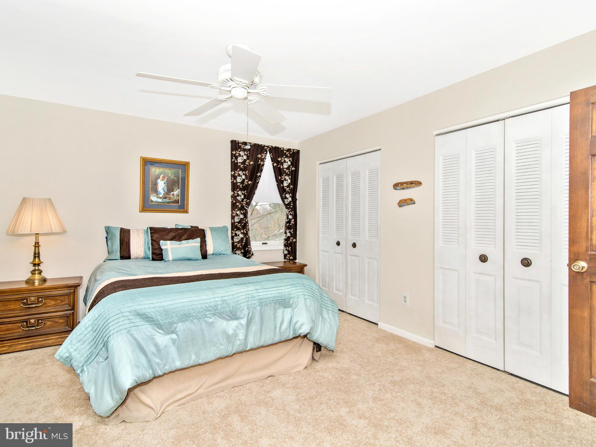 127 Summit Hall Road Gaithersburg, MD 20877 - Photo 19 of 30 a bedroom with a large bed and a chandelier