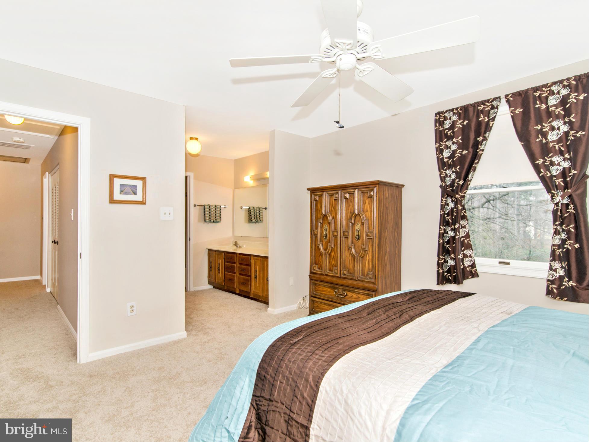 127 Summit Hall Road Gaithersburg, MD 20877 - Photo 20 of 30 a bedroom with a large bed and a chandelier