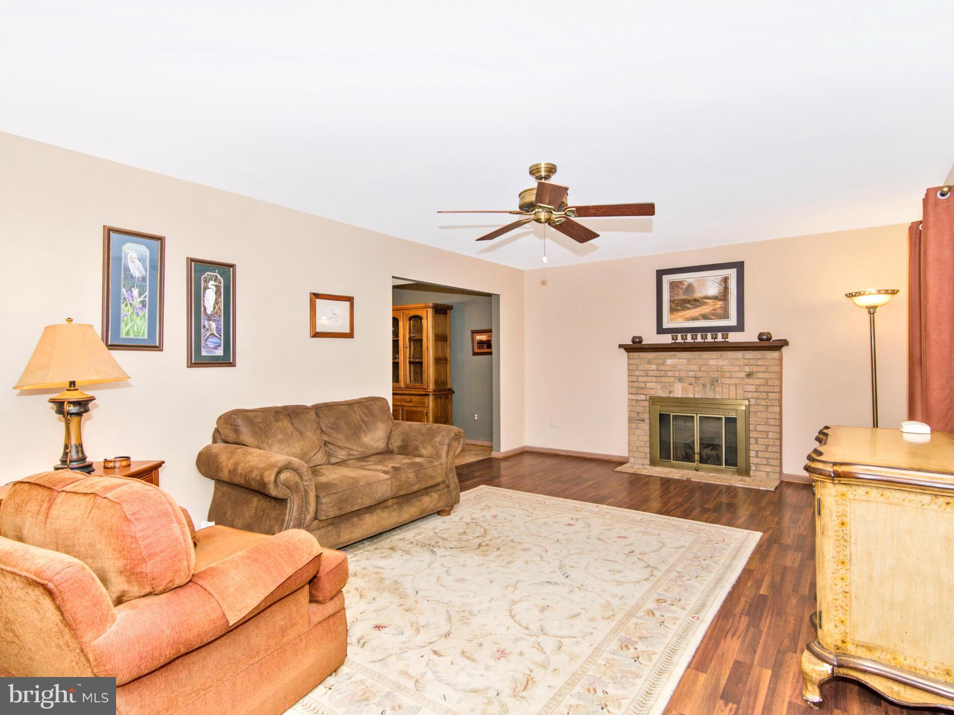 127 Summit Hall Road Gaithersburg, MD 20877 - Photo 7 of 30 a living room with furniture and a fireplace