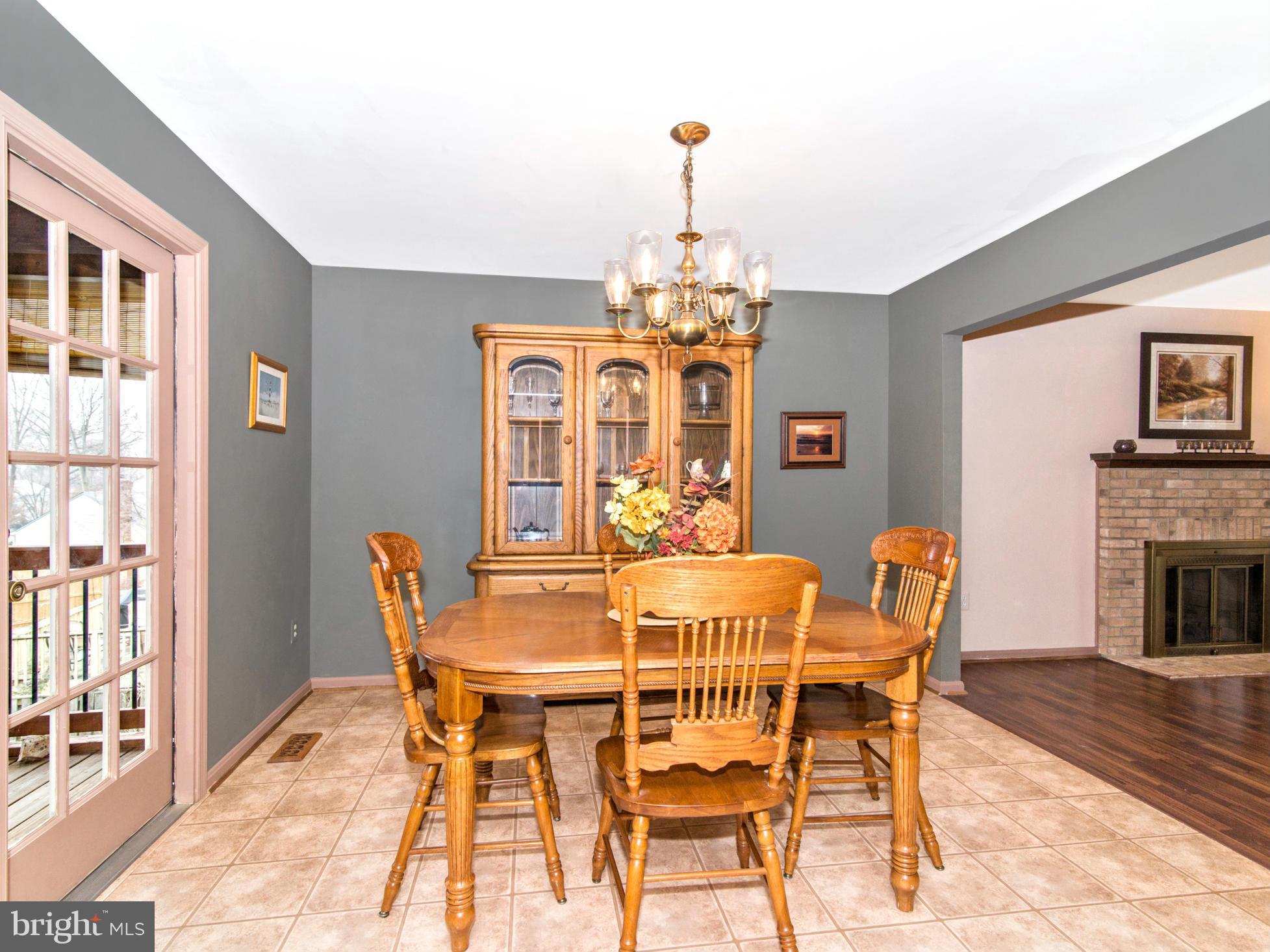 127 Summit Hall Road Gaithersburg, MD 20877 - Photo 8 of 30 a dining room with furniture a chandelier and wooden floor