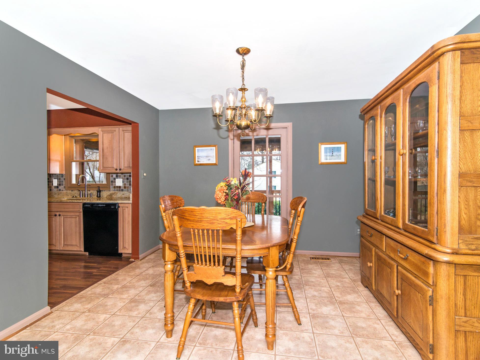 127 Summit Hall Road Gaithersburg, MD 20877 - Photo 9 of 30 a dining room with furniture a chandelier and wooden floor