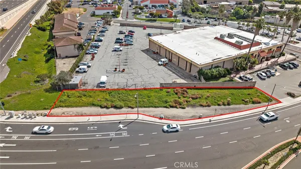 an aerial view of a house with a yard and parking spaces