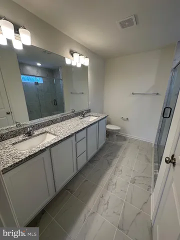 a bathroom with a glass shower door