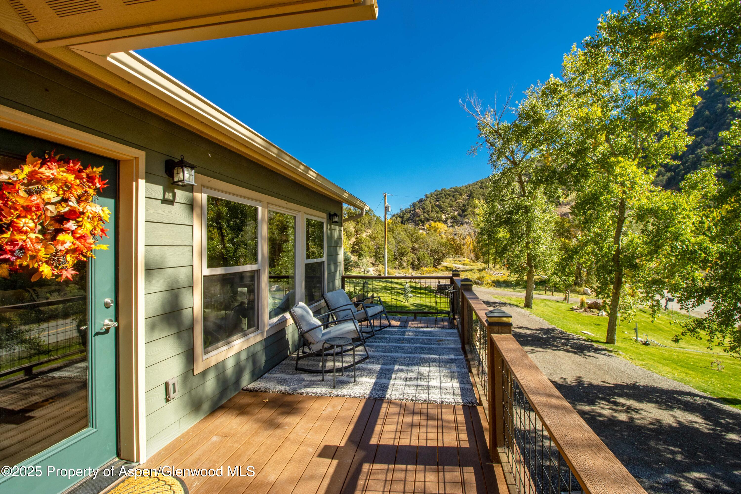 3211 County Road 237 Rifle, CO 81650 - Photo 11 of 56 a view of a patio with table and chairs next to a yard
