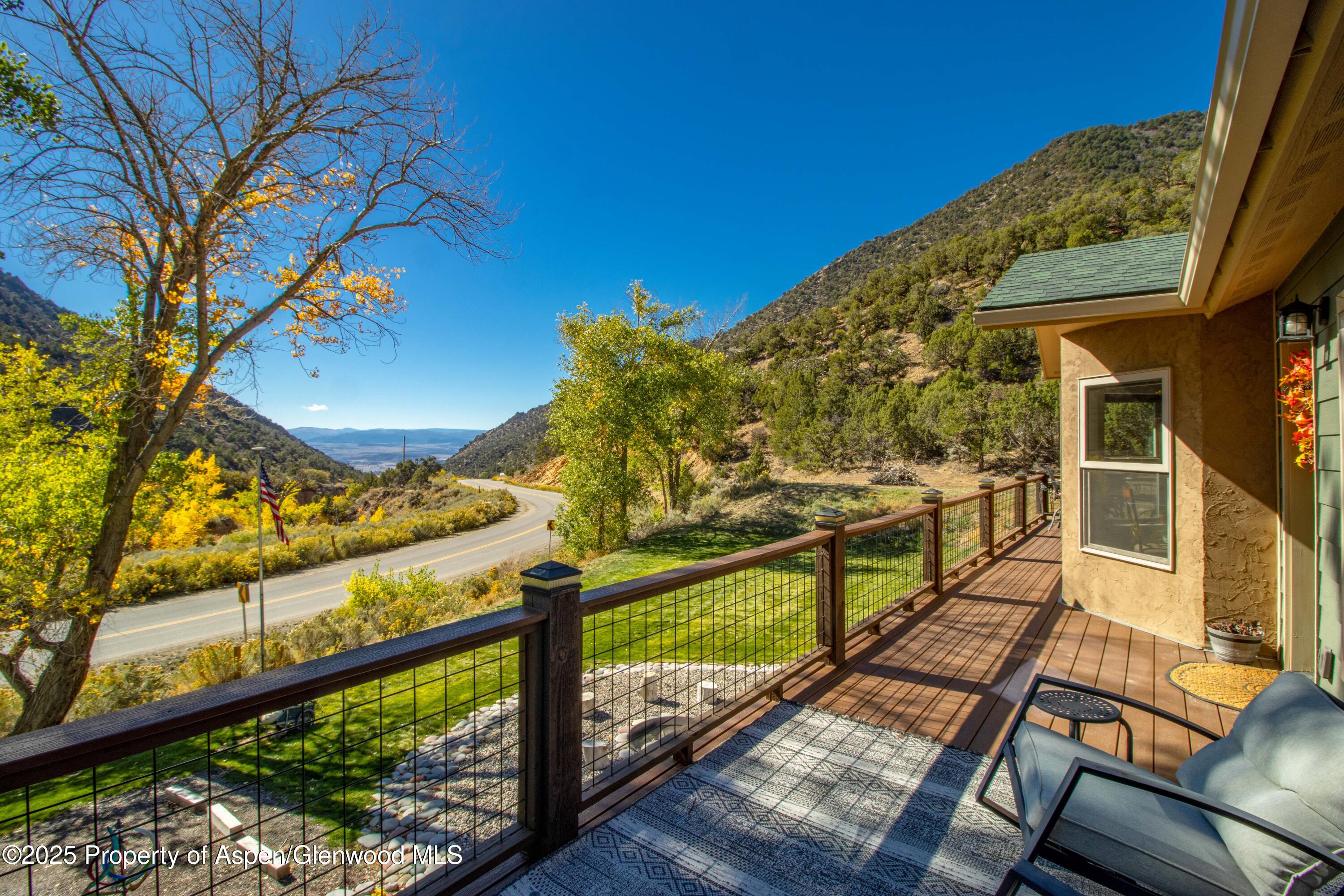 3211 County Road 237 Rifle, CO 81650 - Photo 12 of 56 a view of a balcony with wooden floor and iron fence
