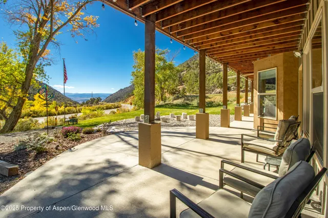 a view of a chairs and table in a patio