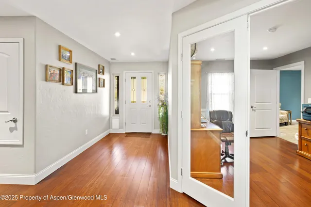 a living room with furniture a flat screen tv and a large window