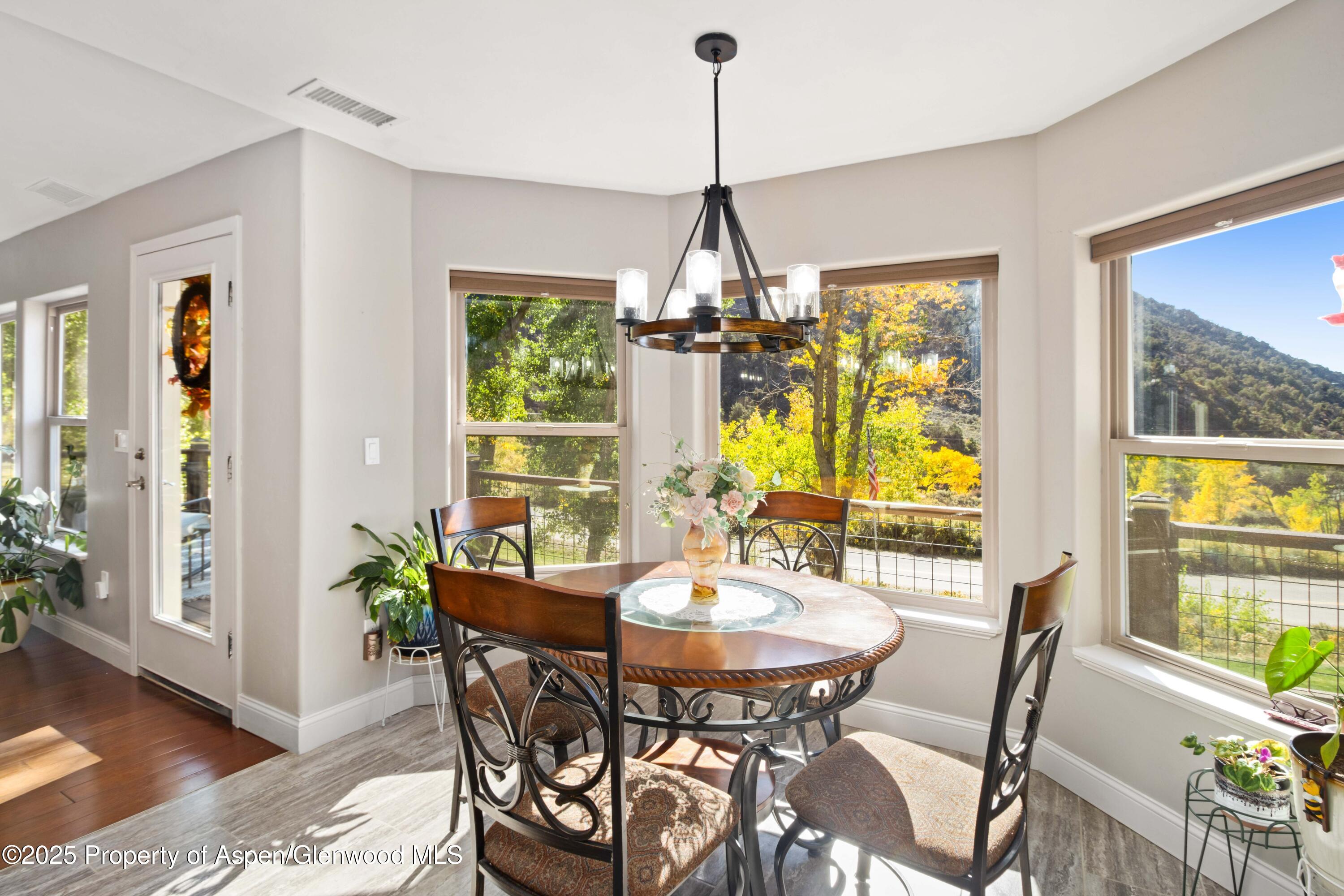 3211 County Road 237 Rifle, CO 81650 - Photo 27 of 56 a view of a dining room with furniture window and wooden floor