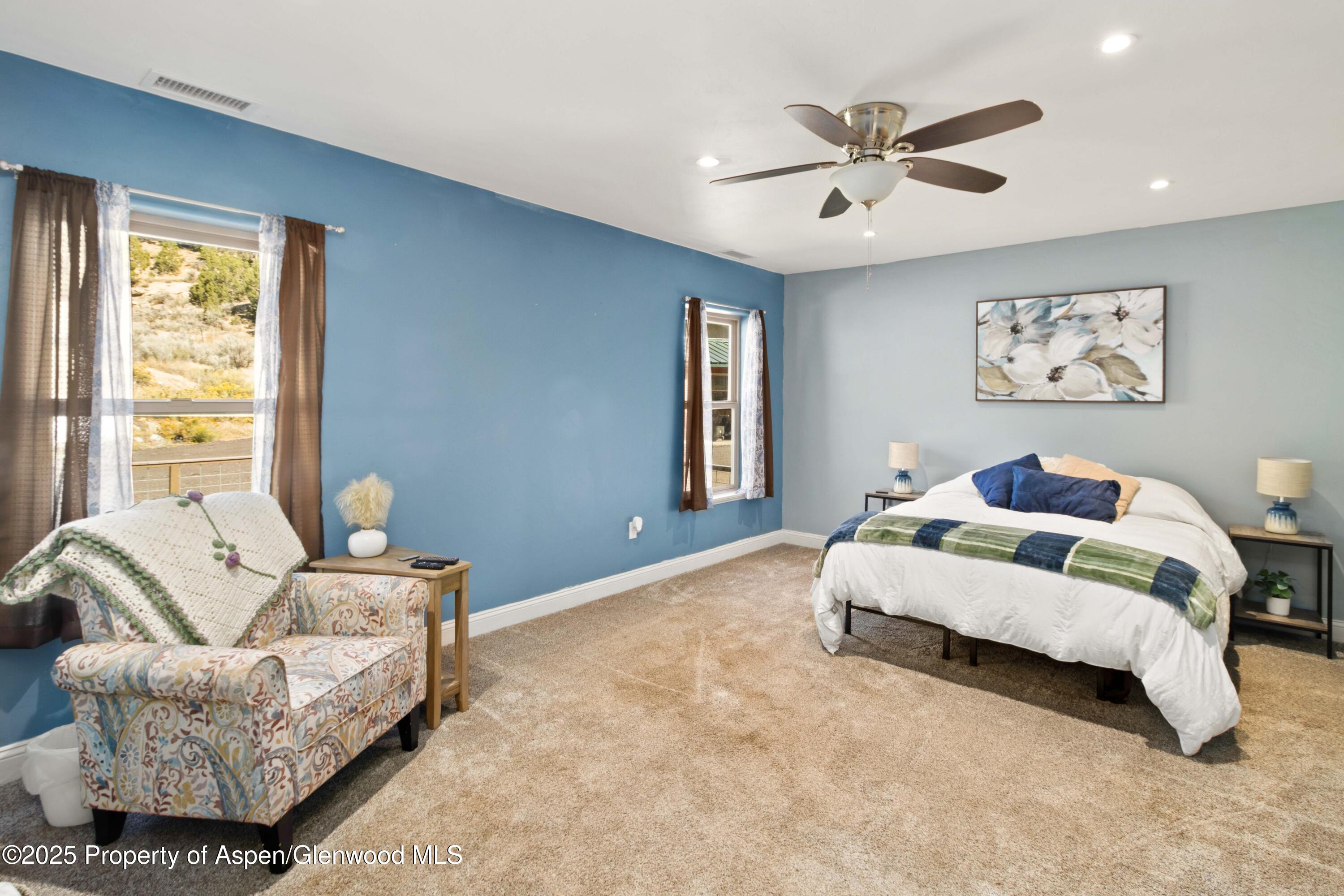 3211 County Road 237 Rifle, CO 81650 - Photo 29 of 56 a spacious bedroom with a bed couch and window