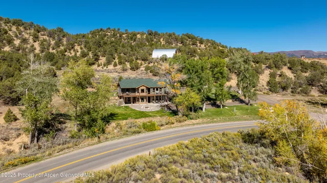 a view of a yard with wooden fence