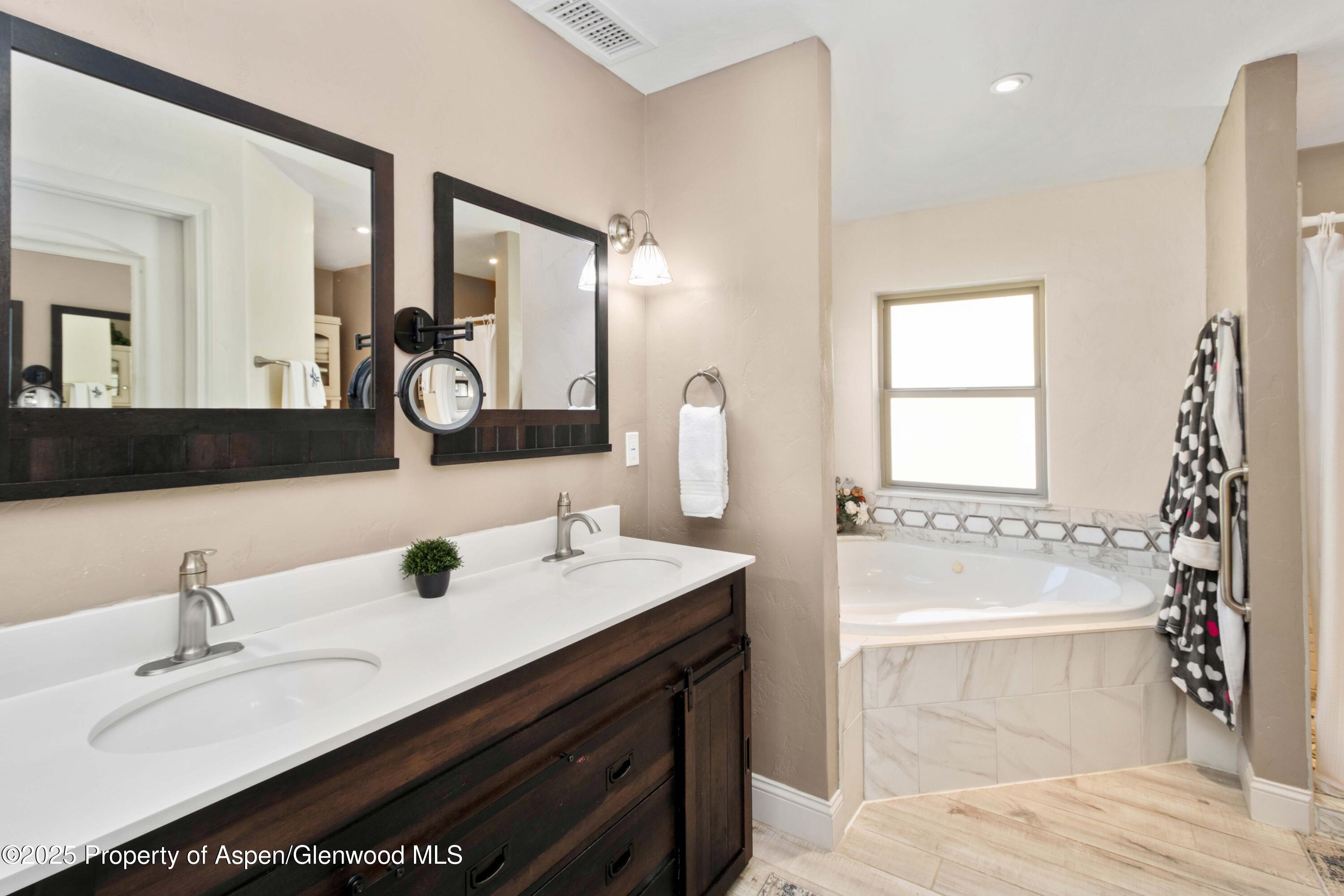 3211 County Road 237 Rifle, CO 81650 - Photo 34 of 56 a bathroom with a tub sink and mirror
