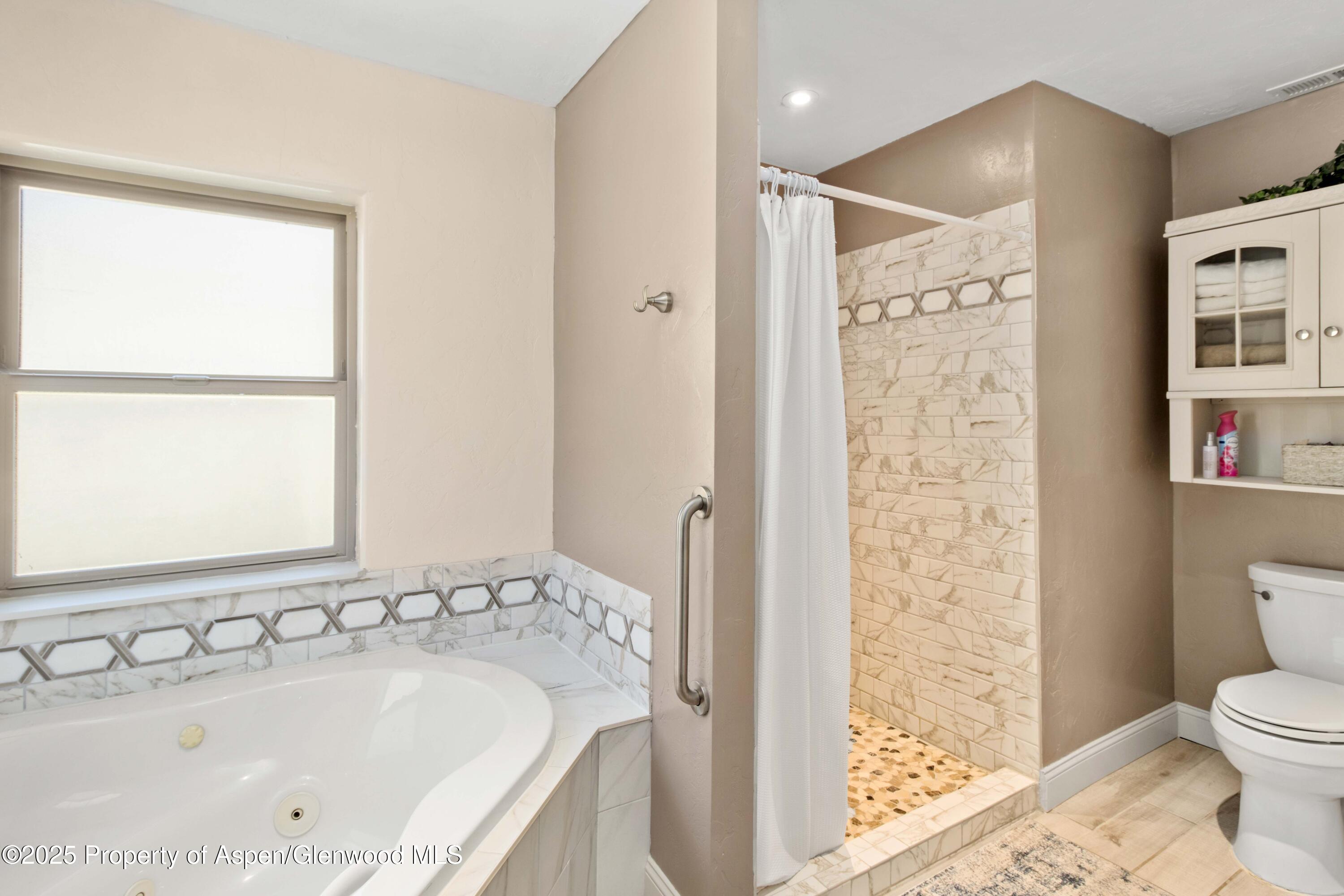 3211 County Road 237 Rifle, CO 81650 - Photo 35 of 56 a bathroom with a tub sink and a toilet