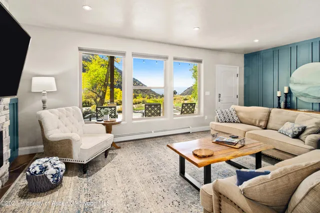 a view of a bedroom with furniture and wooden floor