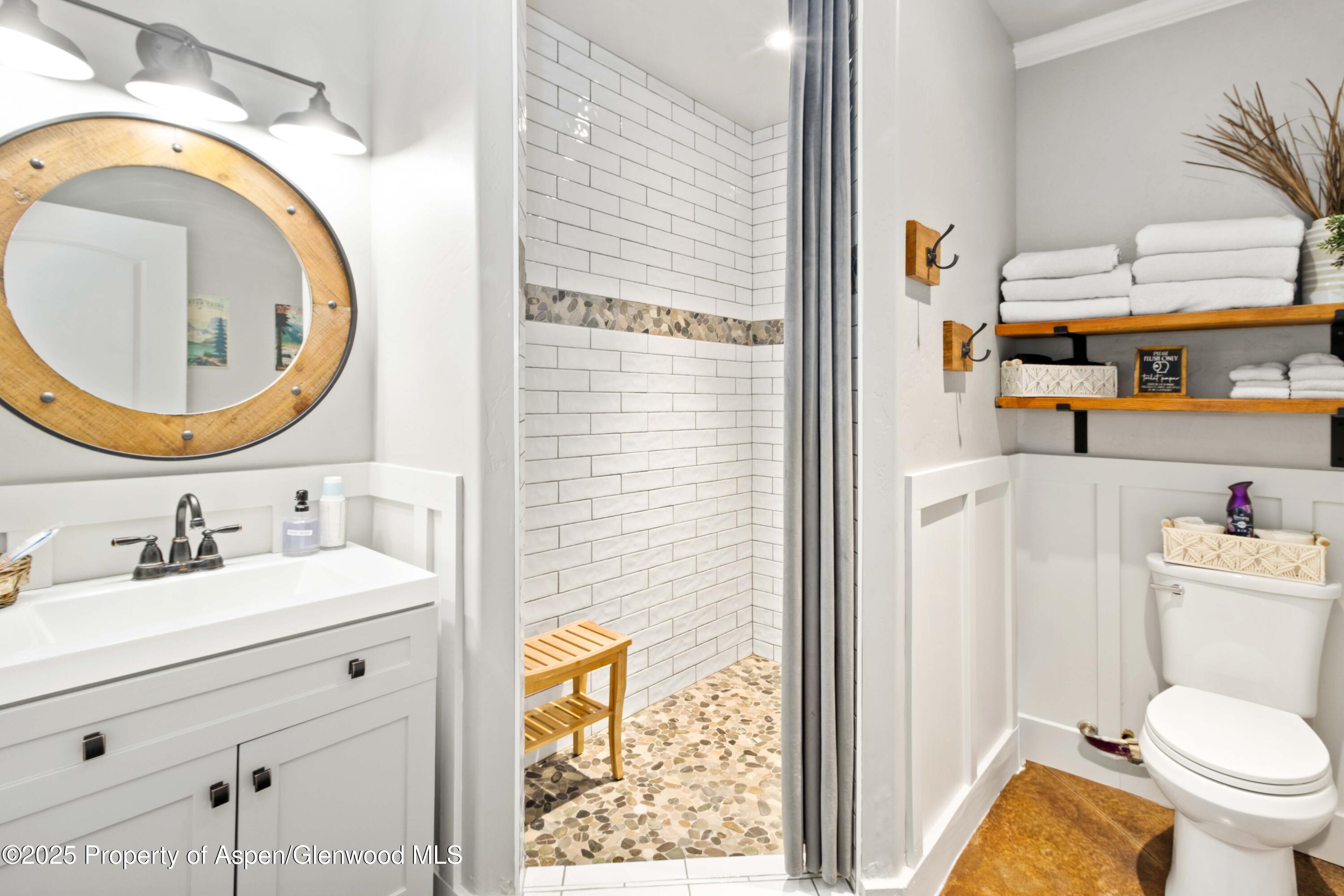 3211 County Road 237 Rifle, CO 81650 - Photo 43 of 56 a bathroom with a sink a mirror and a toilet