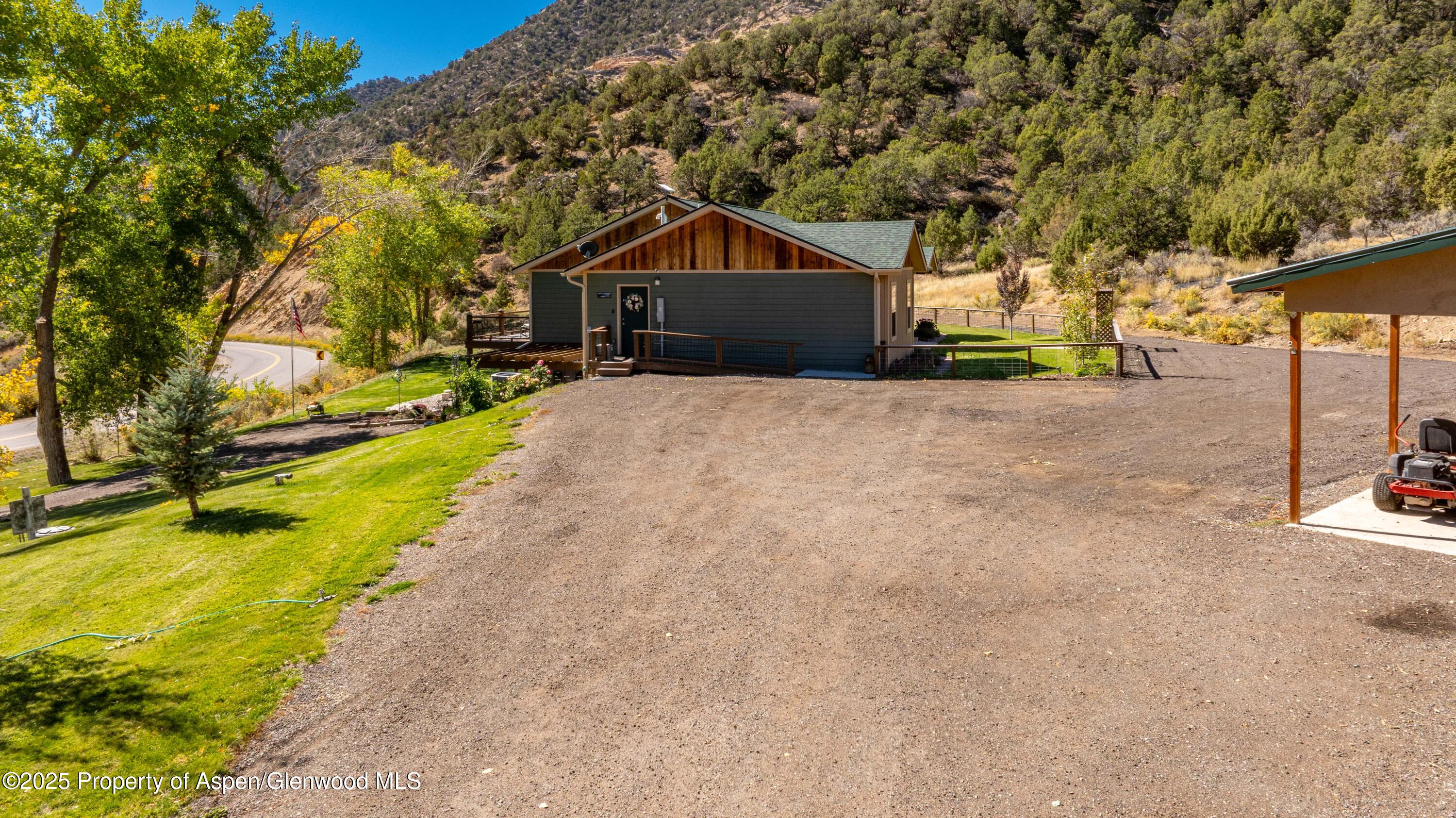 3211 County Road 237 Rifle, CO 81650 - Photo 5 of 56 a front view of a house with a yard and trees