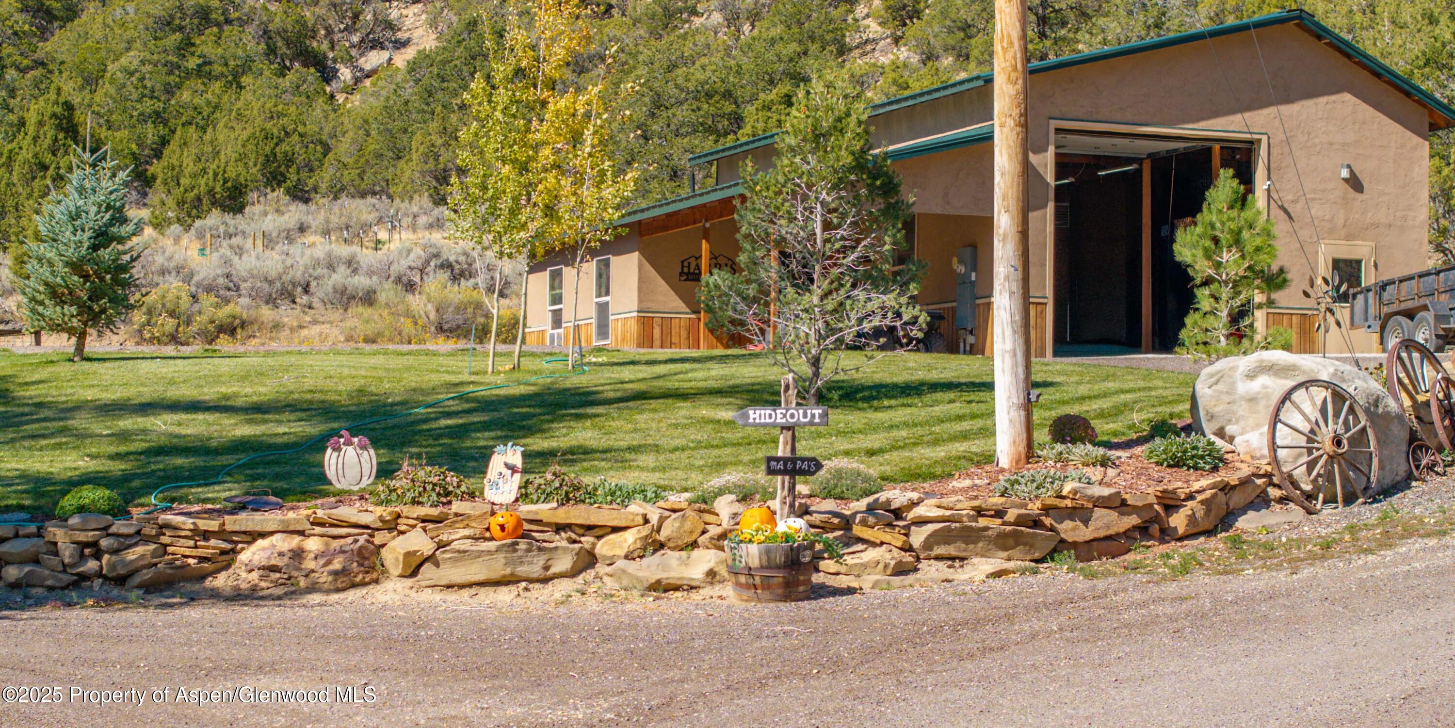 3211 County Road 237 Rifle, CO 81650 - Photo 7 of 56 a front view of a house with garden