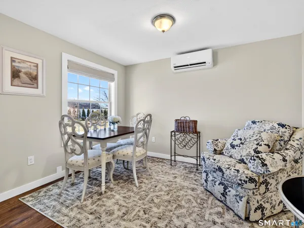 a dining room with furniture and a wooden floor