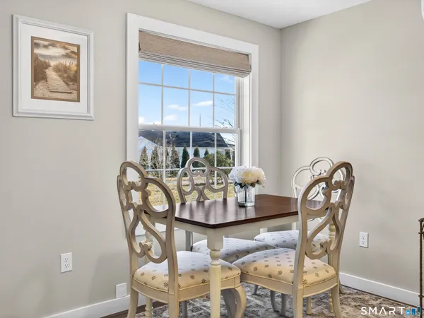 a dining room with furniture a rug and a window
