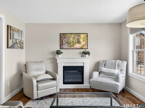 a living room with furniture a rug and a fireplace