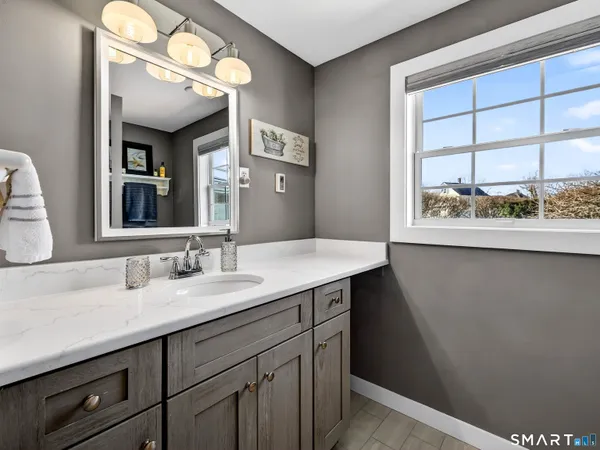 a bathroom with a sink a vanity and a mirror