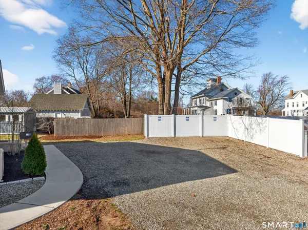 a view of yard covered with snow in front of house