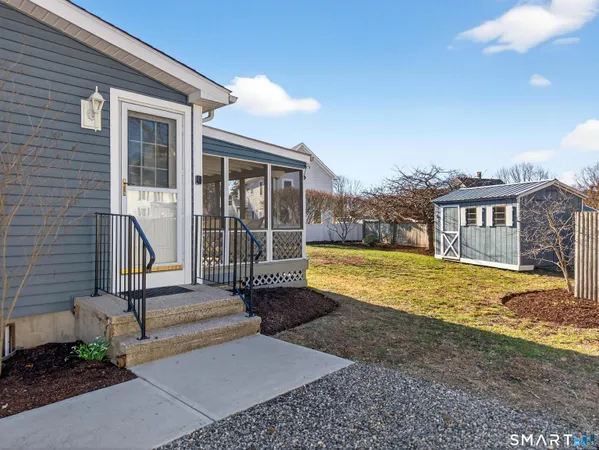 a view of a house with backyard and porch