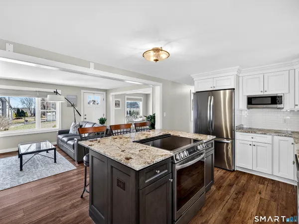 a kitchen with a stove a sink and a refrigerator