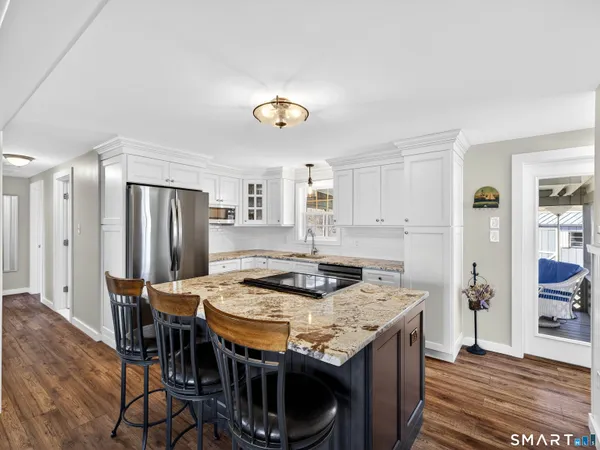 a kitchen that has a table and chairs in it