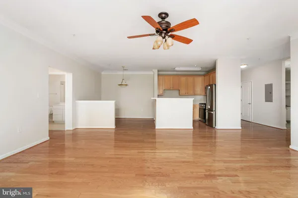a view of a room with a hanging light and kitchen