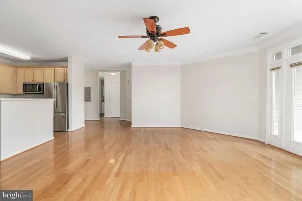 a view of empty room with wooden floor
