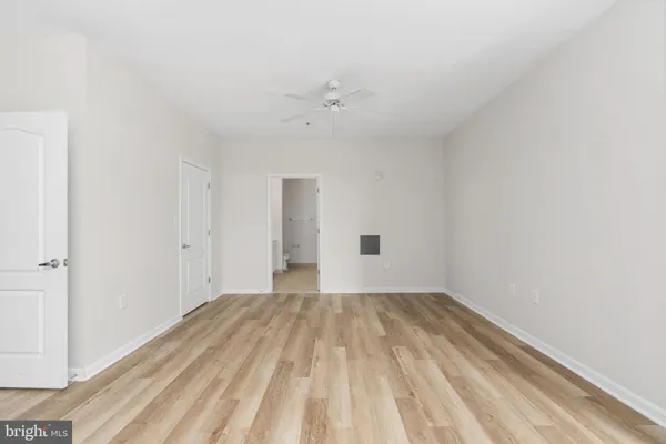 a view of walk in closet with wooden floor