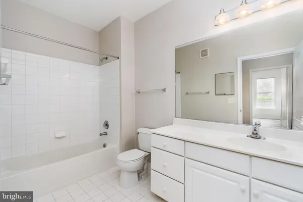 a bedroom with a bed and glass window