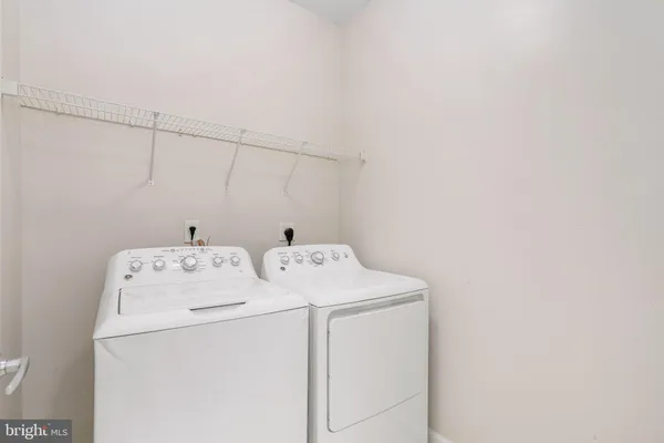 a view of a hallway with wooden floor and entryway
