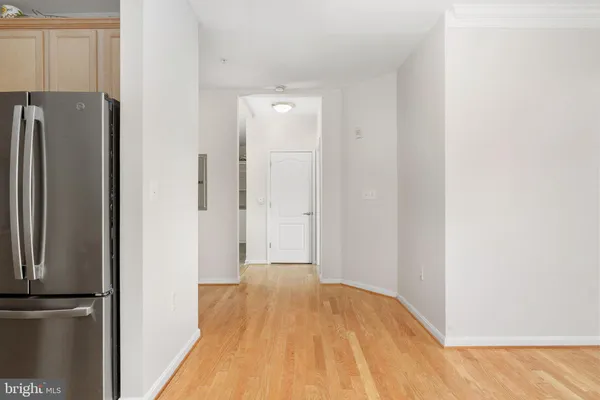 a view of cabinets and utility room with wooden floor