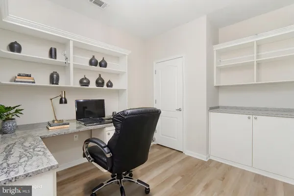 a room with walk in closet and wooden floor