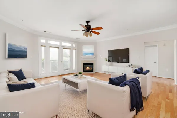 a view of a room with a ceiling fan and window