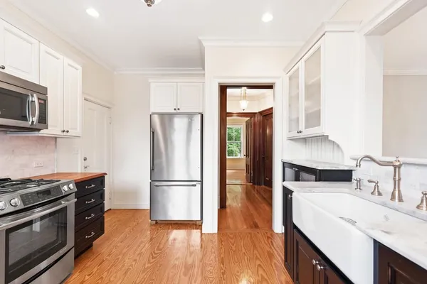 a kitchen with a refrigerator stove and sink